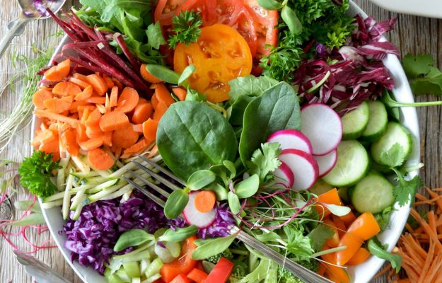 Vibrant, antioxidant-rich organic berries, wild salmon, and avocado arranged elegantly