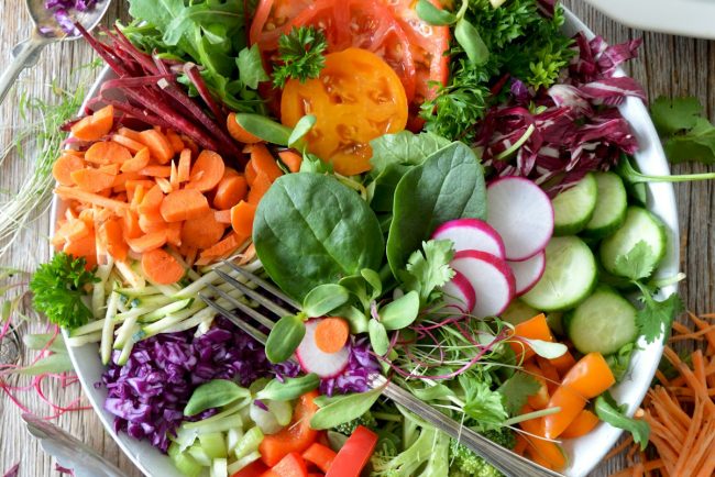 Vibrant, antioxidant-rich organic berries, wild salmon, and avocado arranged elegantly