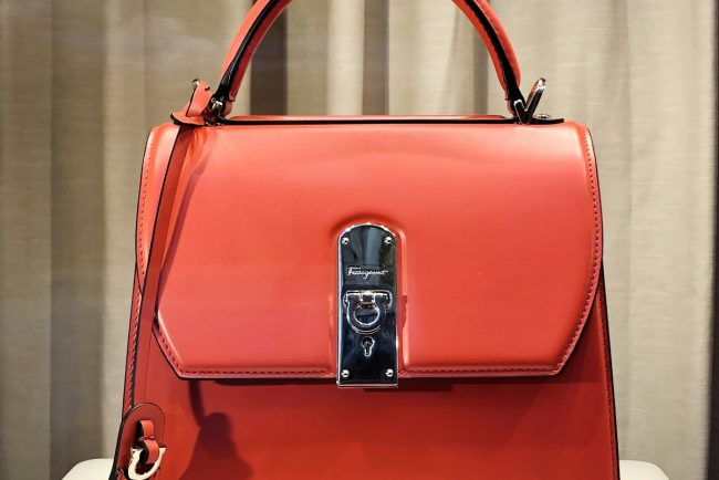 Crafted luxury leather handbag on elegant marble pedestal