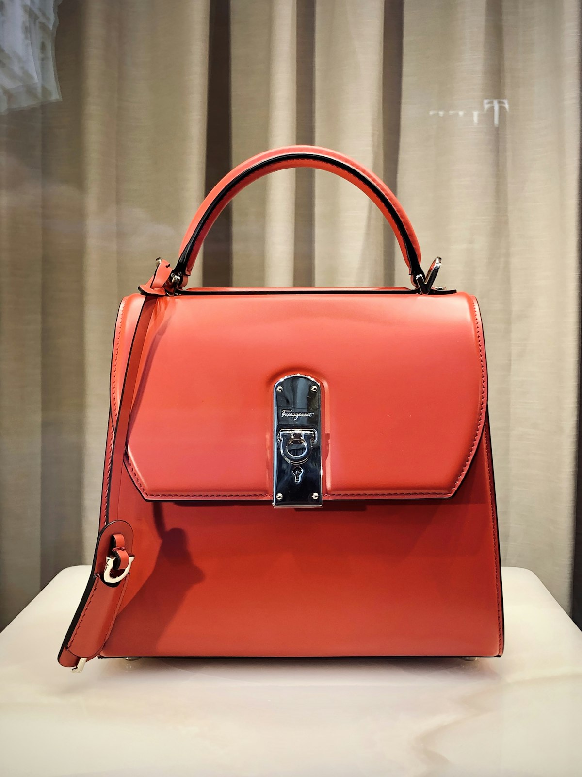Crafted luxury leather handbag on elegant marble pedestal