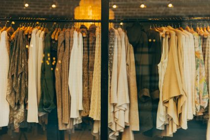 Sophisticated neutral-toned luxury wardrobe pieces arranged aesthetically