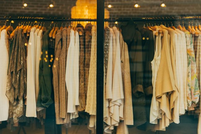 Sophisticated neutral-toned luxury wardrobe pieces arranged aesthetically