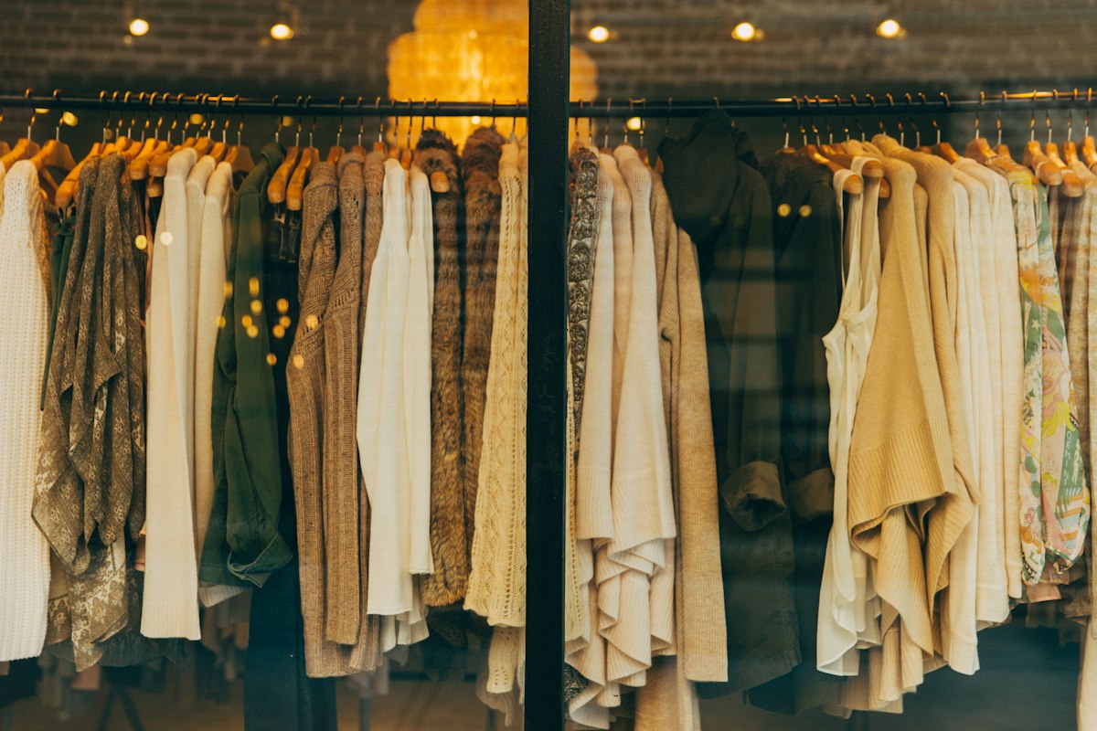 Sophisticated neutral-toned luxury wardrobe pieces arranged aesthetically