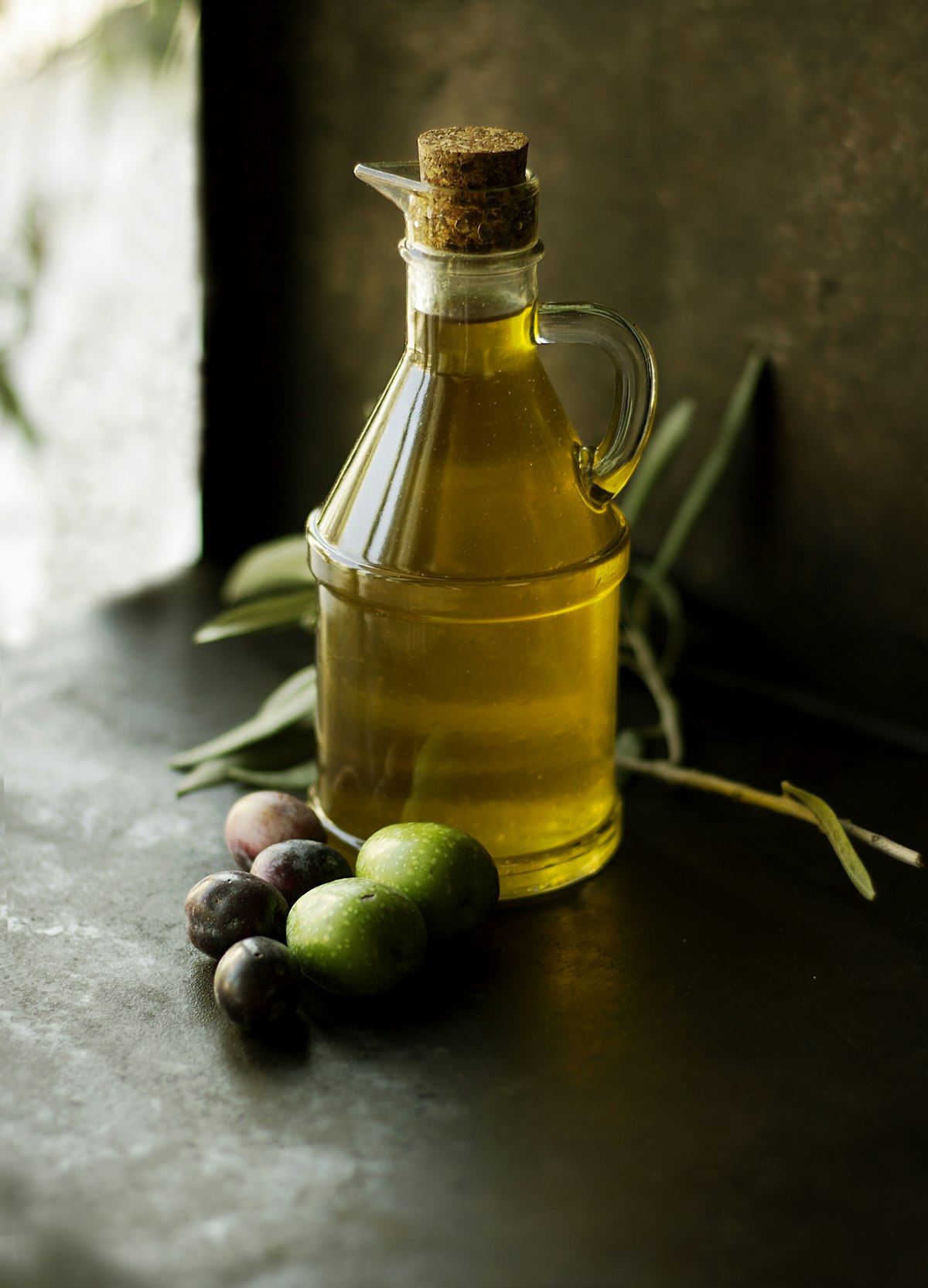 Golden green single-estate extra virgin olive oil drizzled gracefully over rustic artisan sourdough