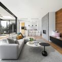Luxurious resort-style outdoor terrace with teak loungers, concrete fire pit, and Mediterranean garden